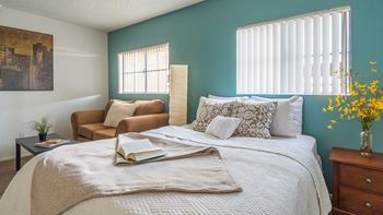 El Encanto spacious bedroom with nice natural lighting and a couch for lounging